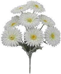 The 17 Gerber Bush with 8 Stems Cream (82495-CR) features lush cream daisies with green stems and leaves. Each flower has a yellow center and multiple white petals, offering vibrant allure against a plain white background for a stunning display.