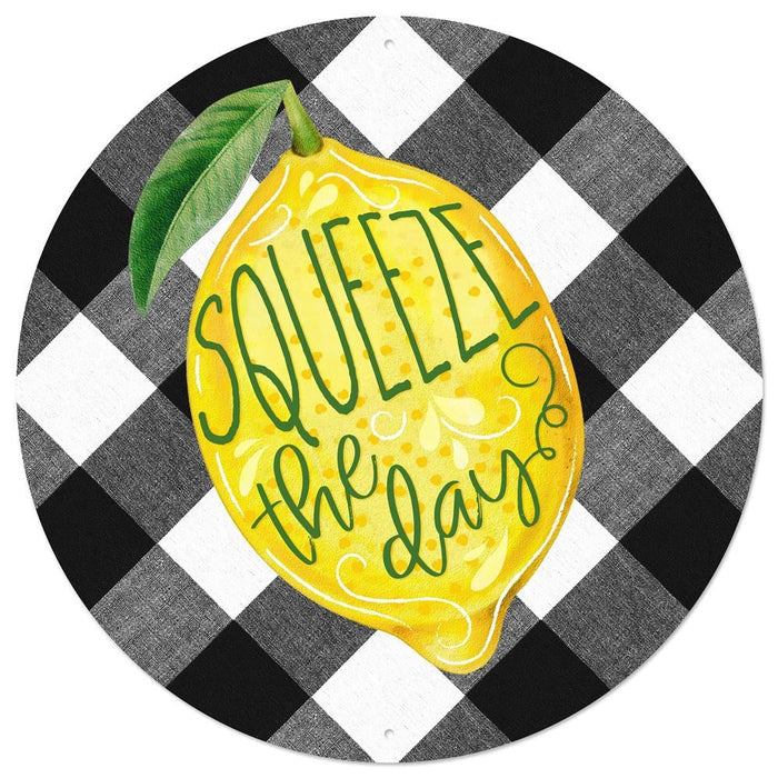 The 12Dia Squeeze The Day Lemon Sign (MD0803) features a large yellow lemon with Squeeze the Day in vibrant green letters, set against a black and white checkered background with a green leaf accent.