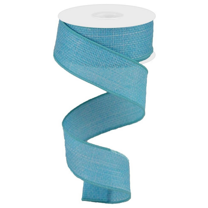 The 1.5 Light Blue Ribbon RG121114, made of polyester with a textured pattern, is spirally unwinding from a white spool against a plain white background.