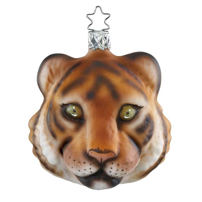 The Jungle Tiger Christmas Ornament Inge-Glas 1-102-16 is handmade in Germany from mouth-blown glass, featuring a detailed tiger’s face with painted eyes, nose, and whiskers, and finished with a star-shaped metal hook.