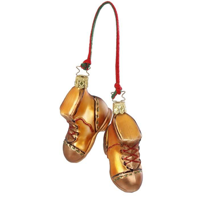 The Forest Hiker Boots Christmas Ornament Inge-Glas 1-188-15 features two golden-brown boots with red laces, hanging side by side from a red and green string, inspired by classic German glass ornaments.
