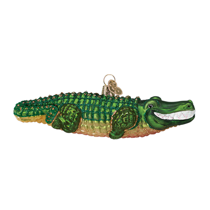 The Alligator 12126 Old World Christmas Ornament features a glittery, smiling green alligator with gold accents and a hanging loop, perfect for festive holiday decor.