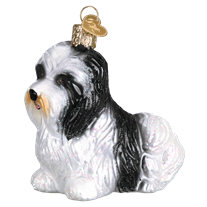 The Havanese Dog 12526 Old World Christmas Ornament is a hand-painted glass piece shaped like a black and white pup sitting, featuring a gold cap and hanging loop.
