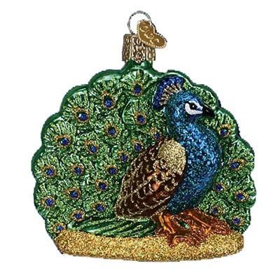 The Proud Peacock Old World Christmas Ornament 16074 is a hand-painted glass ornament shaped like a peacock, featuring a detailed blue and green tail, golden accents, and a hanging loop.