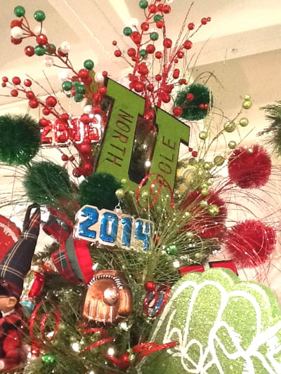 A Christmas tree top featuring RAZ 7" Letter U North Pole Red Green Christmas Ornament Set of 2, with red, green, and silver ornaments, 2014 numbers, and festive branches reading North Pole.