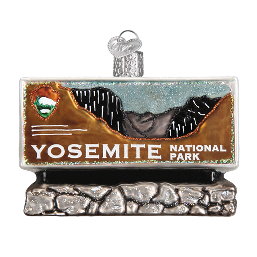 The Yosemite National Park Old World Christmas Ornament 36172 is a decorative piece shaped like the parks sign, featuring Sierra Nevada mountains, a National Park Service emblem, and white lettering on a brown and gold base with a stone-like finish.