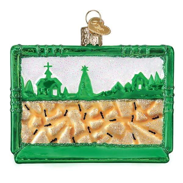 The Ant Habitat 44138 Old World Christmas Ornament is a shiny green book-shaped decoration with a nativity scene and glittery gold “hay” on the bottom, resembling an ant colonys bustling habitat.