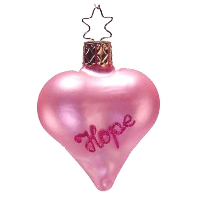The Pink Hope Heart Inge-Glas Christmas Ornament 1-218-06 is a pink, heart-shaped glass ornament with “Hope” in glittery script, finished with a gold cap and star-shaped wire hook—a charming German holiday decoration.