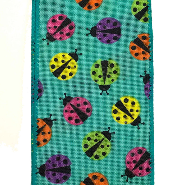 The 2.5 Teal Linen Multicolor Ladybug Ribbon Q917740-33 features rows of pink, yellow, green, orange, and purple ladybugs with black spots—perfect for crafts and décor.