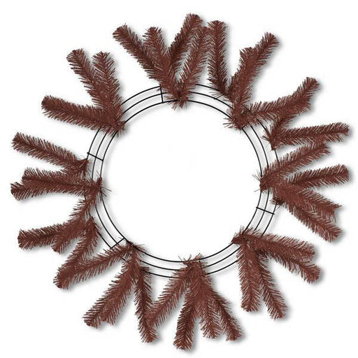 The 24" Work Wreath Chocolate Brown XX748840 features a symmetrical design with artificial pine branches partially covering the chocolate brown frame. The branches extend outward evenly, forming a perfect circular pattern while leaving the center empty.