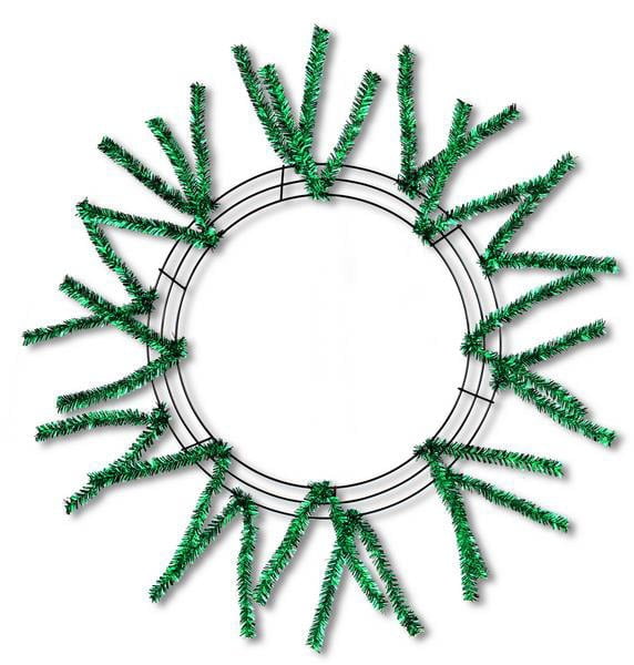 The 24 Pencil Work Wreath Metallic Emerald Green (XX751106) features sparse green artificial pine branches and metallic emerald green mesh on a circular wire base, elegantly set against a white background.