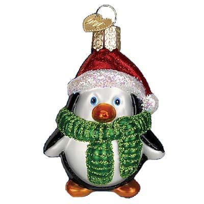 The Playful Penguin 16083 Old World Christmas Ornament features a glass penguin in a red Santa hat and green scarf, with a gold loop for hanging—perfect for adding festive charm to your Old World Christmas collection.