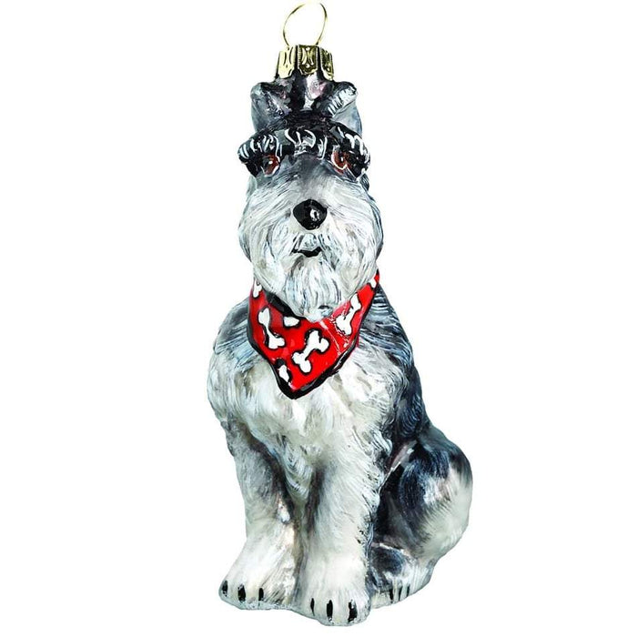 The Schnauzer Gray with Bandana JTW Christmas Ornament ZKP1719B is a mouth-blown piece by European artisans, showcasing a dog in a red bandana with white bone patterns. It includes a gold loop for easy hanging and adds handcrafted charm to your festive decor.
