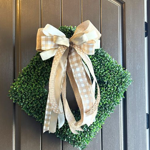 square boxwood wreath, hung diamond shaped with neutral wreath bow