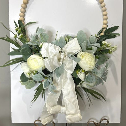how to add florals and ribbon to a wooden bead wreath form