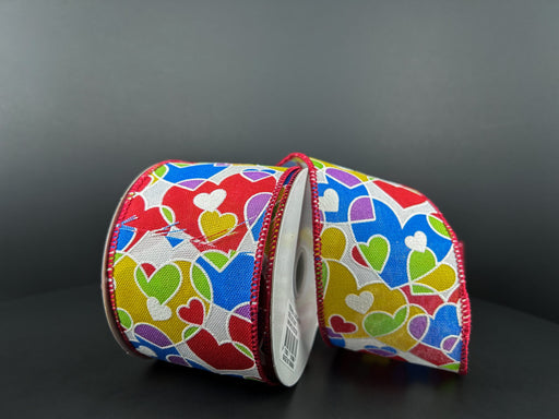 Two spools of white linen ribbon feature yellow, blue, purple, and red overlapping hearts on a dark background with red stitching. Each spool measures 2.5X10Y (Product: 11415-40-39), perfect for adding charm to any craft project.