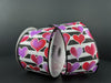 Two rolls of the product "Black And White Satin Stripe/Red-Pink-Lavender Ombre Hearts, 2.5\"X10Y 11416-40-30" are showcased against a dark background.