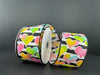 Against a dark backdrop are three rolls of Black and White Satin Stripe Ribbon, featuring 2.5X10Y Pink-Yellow-Blue-Green Ombre Hearts patterns in vibrant colors, creating a striking visual effect.