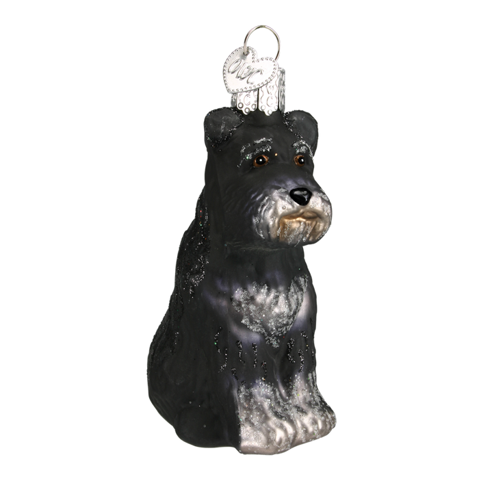 Introducing the Schnauzer Dog 12264 Old World Christmas Ornament Assorted: a black and gray schnauzer-shaped glass piece with shiny details, a metal hanging loop, and a small round tag—perfect for charming your holiday décor.