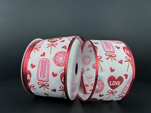 Against a dark background, two spools of White Satin/Valentines Day Candy N Donuts ribbon, 2.5x10Y, boast red-edged designs featuring ice pops, donuts, hearts, and the word Love in red and pink hues—perfectly capturing Valentines Day whimsy.