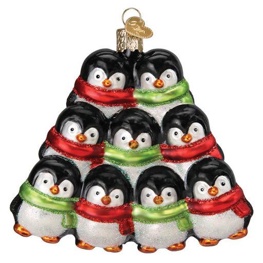 Glass Penguin Family of 9 Old World Christmas Ornament 16156 shaped like a pyramid of nine penguins wearing red and green scarves.