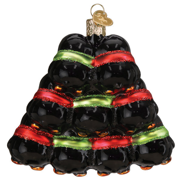 Penguin Family of 9 Old World Christmas Ornament 16156, a glass ornament shaped like a pyramid of nine black penguins decorated with red and green glittery ribbons.