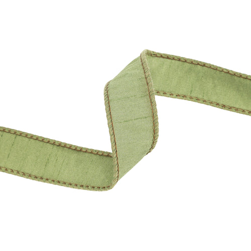 A close-up of the 1″ Designer Moss Dupioni Wired Ribbon 9100W-570-25E, featuring light green dupioni fabric with brown stitched edges, twisted into an S-shape against a white background. Ideal for adding texture and elegance to autumn wreaths.