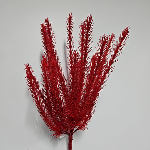 A spray of the bright red, feathery branches from the 16" Red Christmas Salix 83552-RD against a simple light gray backdrop showcases its textured and upright design, with the central branches rising prominently.