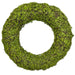 The 18 Inch Green Moss Wreath (13654WR18) features lush leaves and foliage on a sturdy wire, vine, and moss base with a hollow center, displayed against a white background—perfect for wreath making.
