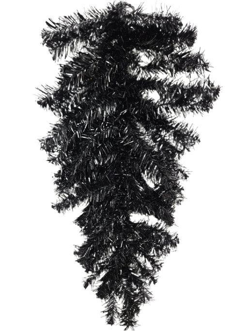 The 24 Halloween Teardrop Black 82298-BK hangs upside down against a white wall, featuring shiny black needle tinsel branches with no decorations.