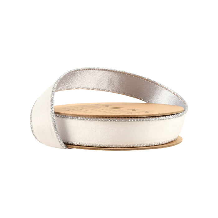 A spool of 1" White and Silver Reversible Classic Velvet Ribbon (7115W-029-25E), partially unrolled and wrapped around a cardboard core, is displayed against a plain white background.