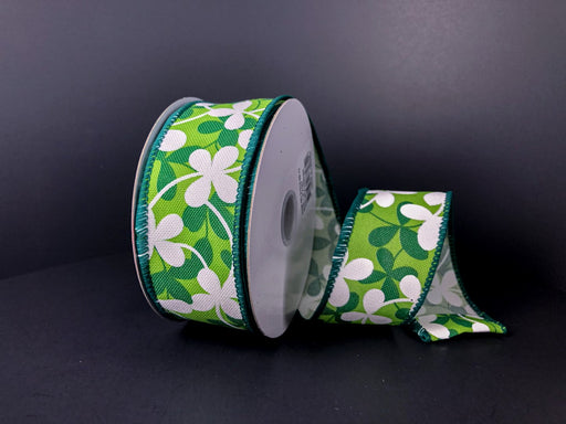 This Linen Green Clover Flowers ribbon (1.5X10Y, 21213-09-17) features St. Patricks Day charm with white shamrocks and clover flowers on a green hue, dark green edge, and dark background.