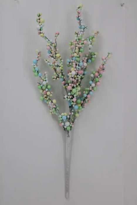 The 22 Inch Pastel Berry Spray 23185 features small pink, blue, green, and yellow beads on thin stems, arranged on a plain light gray background for a charming artificial floral accent.