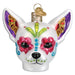 The Dia De Los Muertos Dog Ornament Old World Christmas 26097 is a white ornament adorned with vibrant, glittery patterns inspired by the Mexican Day of the Dead celebration and Old World Christmas traditions, featuring flowers around the eyes and bright colors on the ears and forehead.