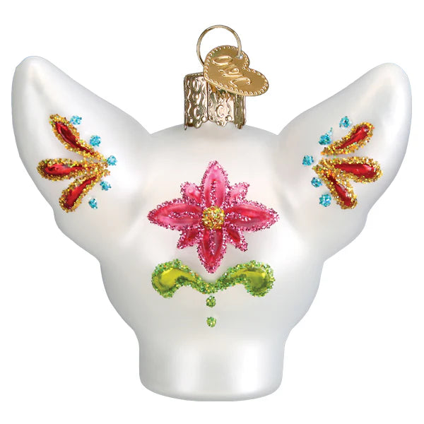 The Dia De Los Muertos Dog Ornament from Old World Christmas (26097) features a white dog’s head adorned with vibrant glitter designs in red, pink, green, yellow, and blue, topped with a gold cap—making it a unique and festive choice for Mexican holiday celebrations.