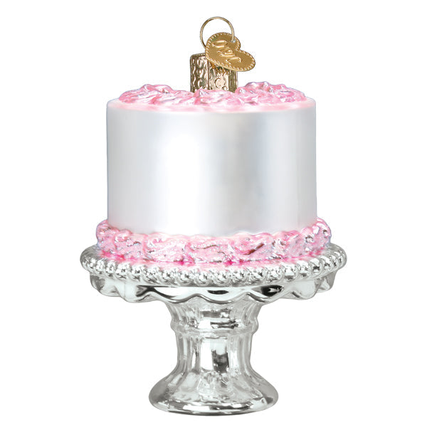 Cake on a Stand Old World Christmas Ornament 32618 featuring a white cake with pink frosting displayed on a silver pedestal stand.