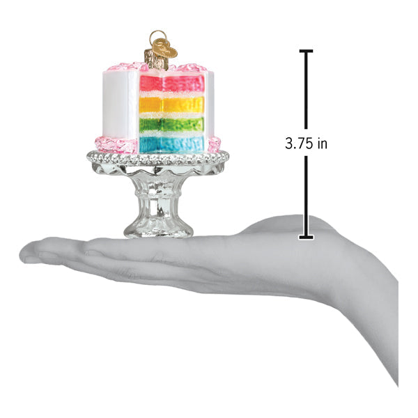 A hand holds a Cake on a Stand Old World Christmas Ornament 32618, a multi-colored cake on a pedestal stand, with a graphic showing its 3.75-inch height.