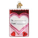 A Conversation Hearts Candy Old World Christmas Ornament 32623 shaped like a rectangular valentine card, featuring a white heart in the center with lines for To and From and two small red hearts at the bottom.
