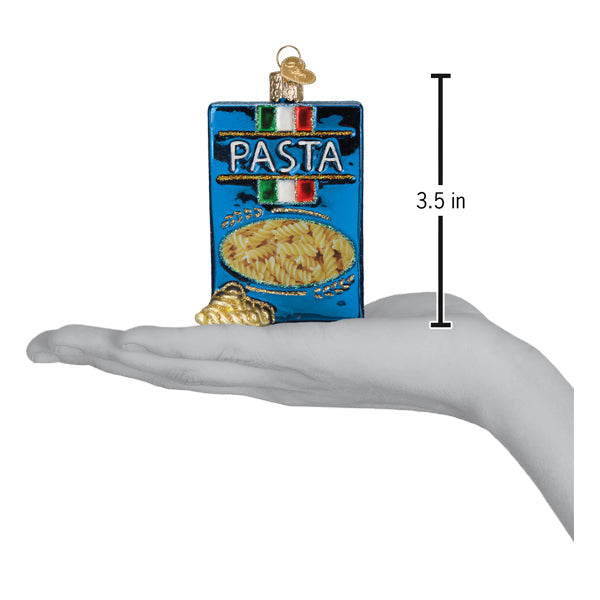 A hand holds a 3.5-inch Box of Pasta Old World Christmas Ornament 32627 shaped like a blue box of pasta.