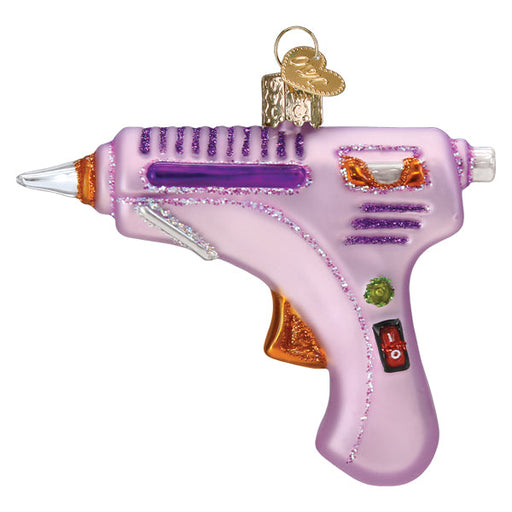 Hot Glue Gun Old World Christmas Ornament 32629, a light purple glass ornament shaped like a glue gun with glitter accents, perfect for crafters.