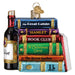 Book Club Old World Christmas Ornament 32653, a glass ornament shaped as a stack of books titled The Great Gatsby, Hamlet, Book Club, A Christmas Carol, The Secret Garden, and Jane Eyre, sitting next to a wine bottle.