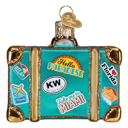 Miami Suitcase Old World Christmas Ornament 32659 is a teal suitcase ornament decorated with travel-themed stickers, including Hello Paradise, I heart Florida, and Take me to Miami.