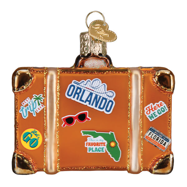 Orange glass Orlando Suitcase Old World Christmas Ornament 32660 decorated with travel-themed stickers, including a map of Florida and sunglasses.