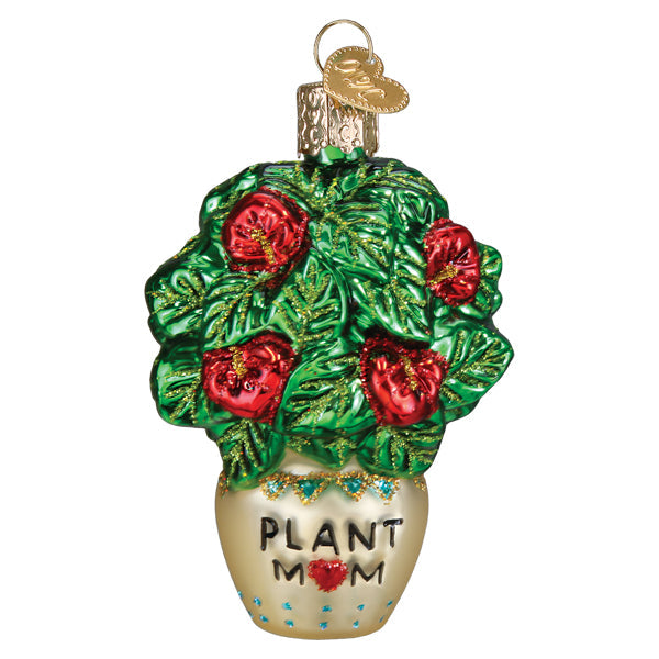 Plant Mom Old World Christmas Ornament 36341, a glass ornament of a potted plant with green leaves, red flowers, and the text PLANT MOM written on the cream-colored pot.