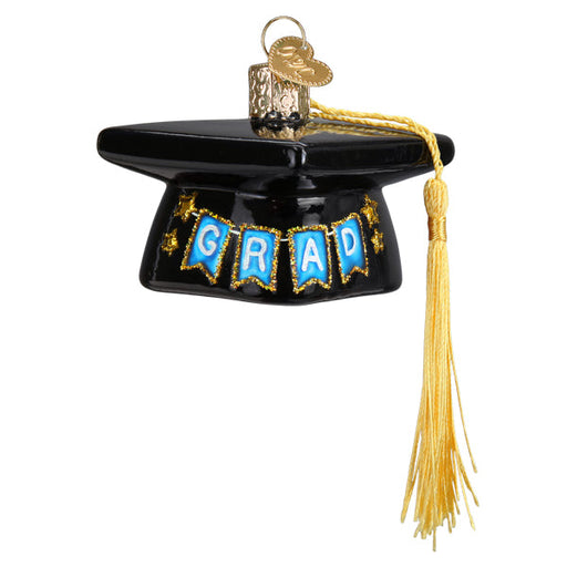 Graduation Cap Old World Christmas Ornament 36342 is a black graduation cap ornament featuring a gold tassel and blue pennants spelling GRAD, ideal as a graduation gift.