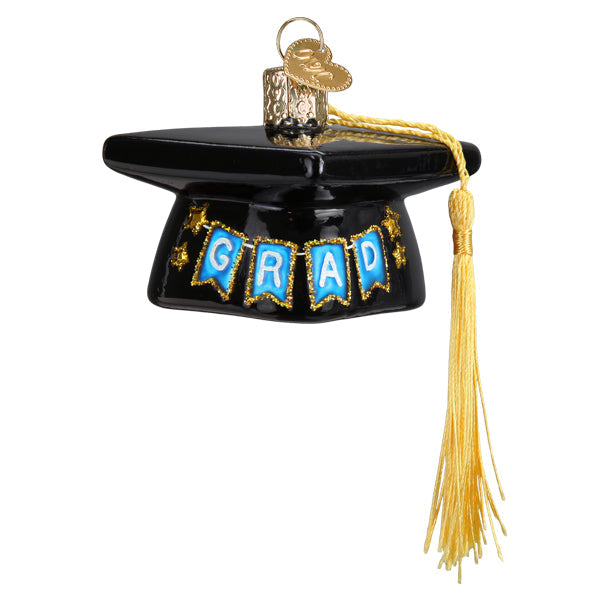 Graduation Cap Old World Christmas Ornament 36342 is a black graduation cap ornament featuring a gold tassel and blue pennants spelling GRAD, ideal as a graduation gift.