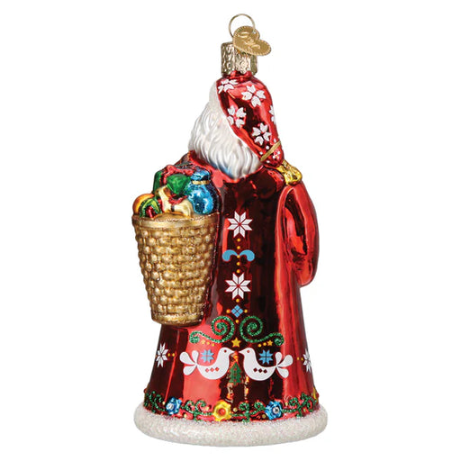 The Norwegian Santa Old World Christmas Ornament 40348 features a festive Julenisse in a red coat adorned with white snowflakes, holding a basket of colorful gifts, and is beautifully detailed from the back.