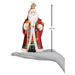 A hand holds a 6.5-inch tall Norwegian Santa Old World Christmas Ornament 40348, featuring Julenisse in a red robe with gold and floral accents, white beard, black boots, and a top hanging loop.