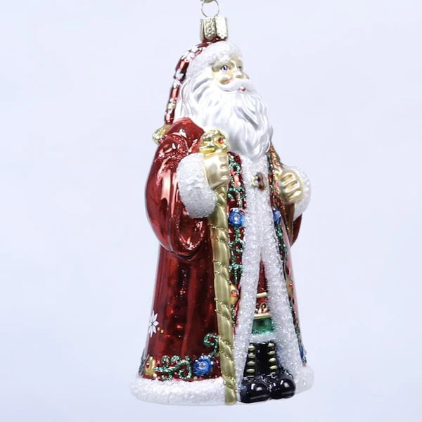 The Norwegian Santa Old World Christmas Ornament 40348 is a festive glass piece shaped like Santa Claus in a red coat with white trim, colorful details, and staff, set against a plain white background.