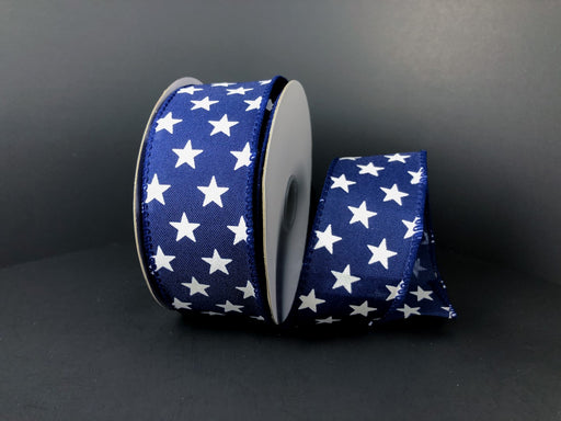 A partially unwound roll of 1.5X10Y Navy Satin/White Stars Ribbon 41223-09-27, featuring dark blue tones and delicate white stars, sits on a solid dark background.
